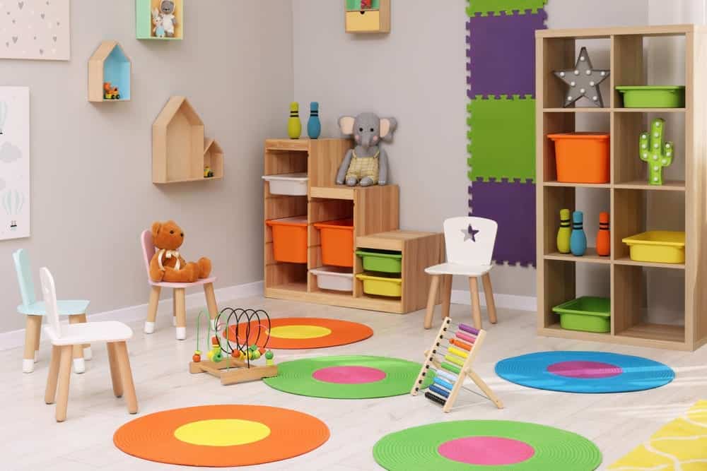 children's play room with chairs and toys and mats