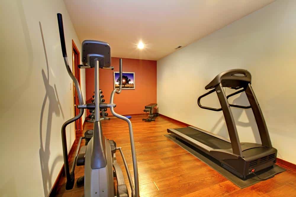underground gym with treadmills and elliptical machine